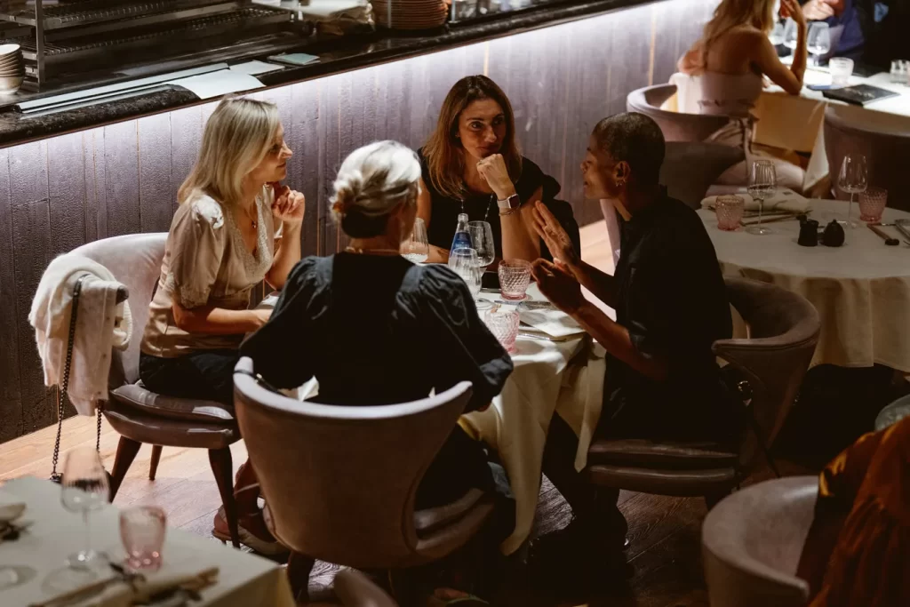 A group of people dining at a table in a restaurant near Harrods.